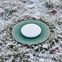 Sprinkler-Guard Cover sealed on the guard in a frosty winter lawn